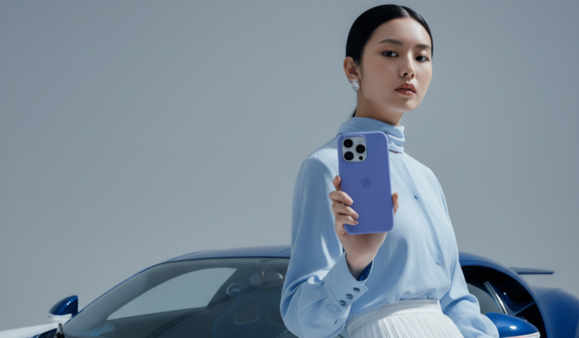 Woman holding a phone in front of a futuristic vehicle